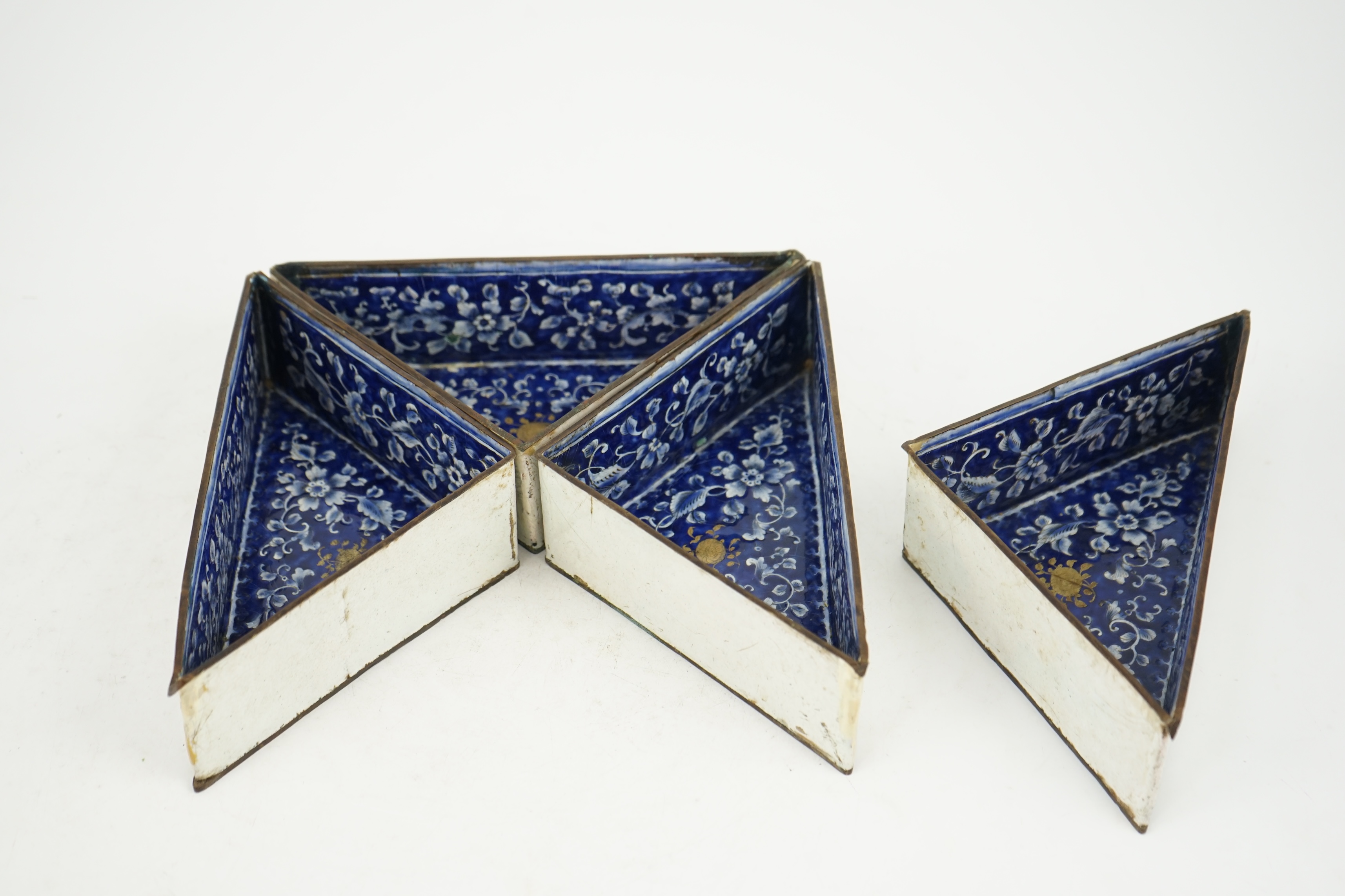 Four triangular 19th century Chinese Canton enamel sectional dishes, later boxed, 24cm wide overall. Condition - some restoration